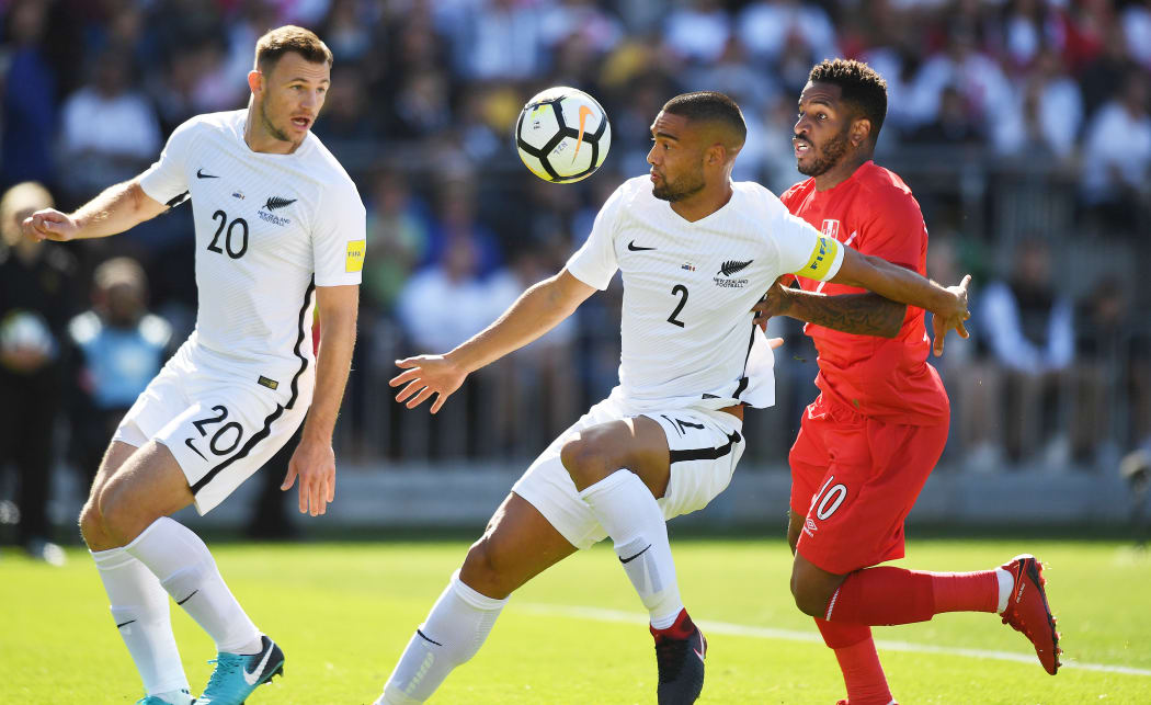 New Zealand's WInston Reid and Peru's Jefferson Farfan.