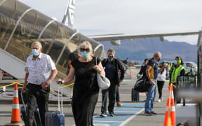 Passengers arriving in Queenstown on the first flight from Auckland on 15 December 2021.