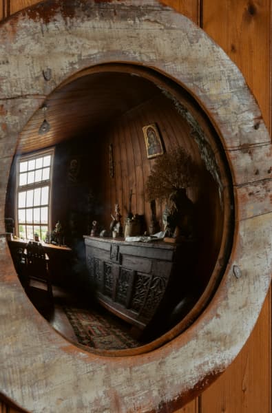 Driftwood staves, or sentinels, stand in the corners; atop one sits the puppet Twinkle in the Eye.