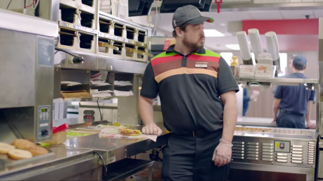 Burger King staff member punches a customer's burger