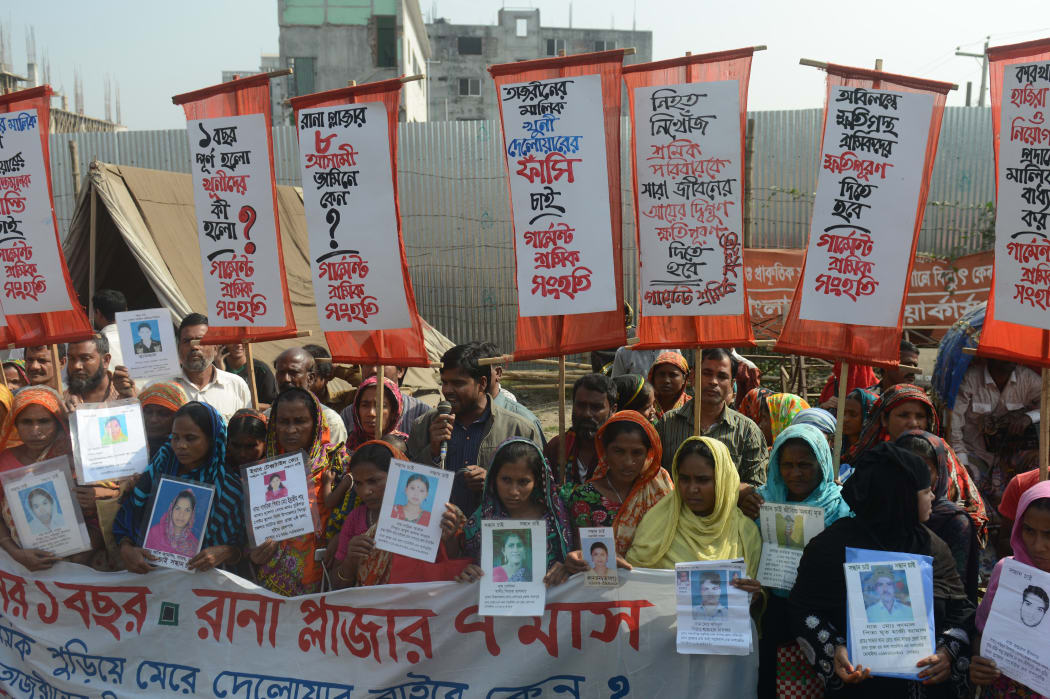 Survivors and relatives of Bangladeshi garment workers killed in the Tazreen Fashions fire accident and Rana Plaza garment factory building collapse react gather for a demonstration in Savar, on the outskirts of Dhaka on November 24, 2013.