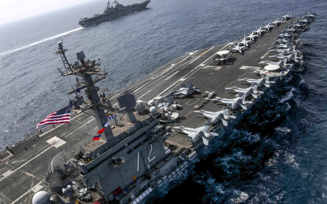 Aircraft carrier USS Abraham Lincoln  and the Amphibious Assault Ship USS Kearsarge (LHD 3) sail in the Arabian Sea in May.