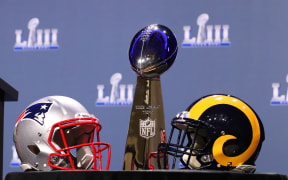 The Vince Lombardi Trophy and New England Patriots and Los Angeles Rams helmets 2019.