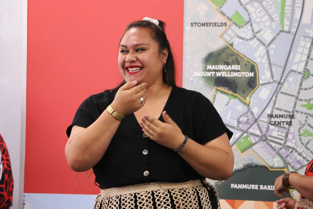 Tongan parliamentary staffer Veisinia Latu performs with Tāmaki Regeneration Company staff in Auckland