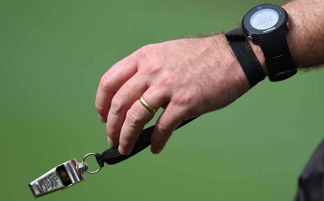 Referee watch, whistle and wedding ring.