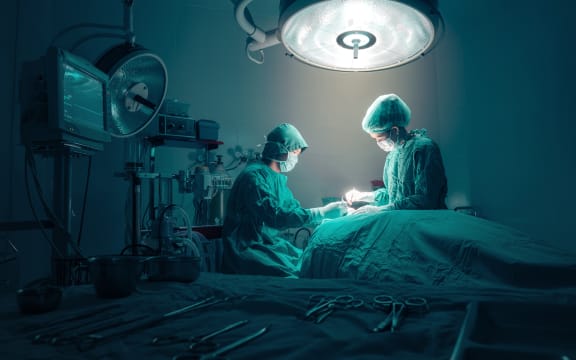 Surgeons team working with Monitoring of patient in surgical operating room.
