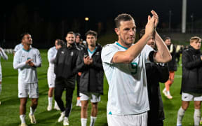 Chris Wood of New Zealand applauds after their 4-0 win over Malaysia.