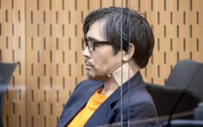 Tingjun Cao in the Christchurch High Court wearing a bandage on his neck.