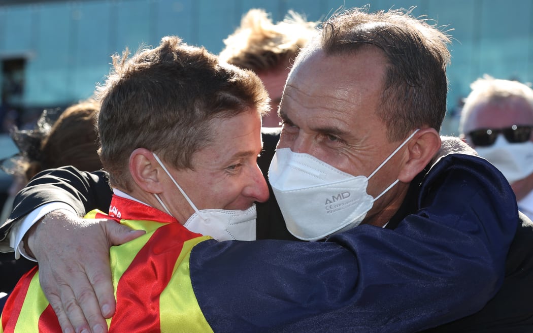 Jockey James McDonald, left, embraces trainer Chris Waller after Nature Strip's victory in The Everest at Royal Randwick Racecourse in Sydney on October 16, 2021. (Photo by DAVID GRAY / AFP) /