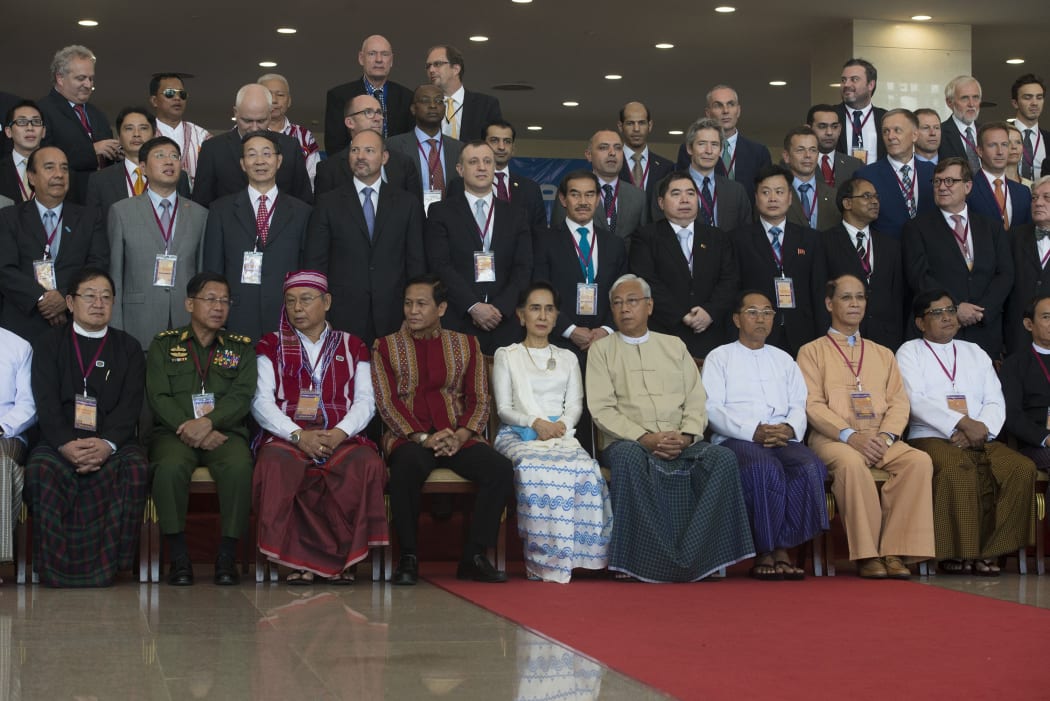 Myanmar's President Htin Kyaw,fourth from the right, sit nexts to Aung San Suu Kyi in a group photo after the opening of Union Peace Conference.