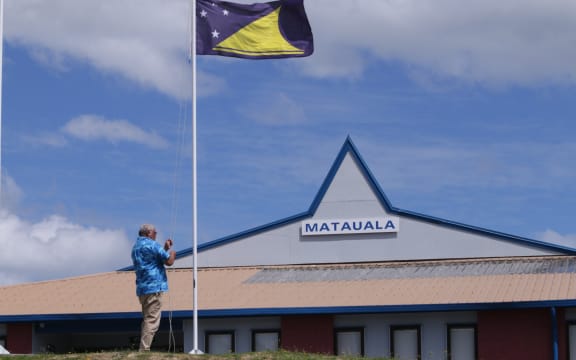 The President of the Atafu Tokelau Community Group, Lehi Tenise Atoni, raises the Tokelau flag outside the group's community centre in Porirua.