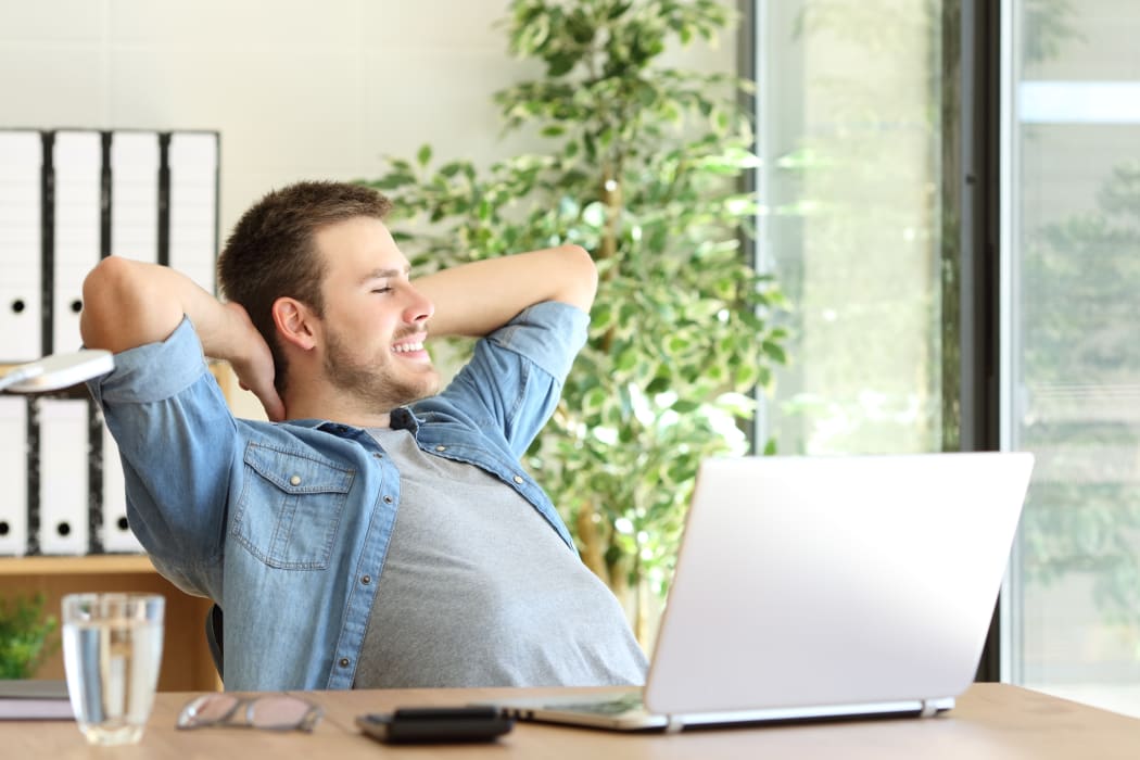 Worker looking outside office window, thinking. (File photo)