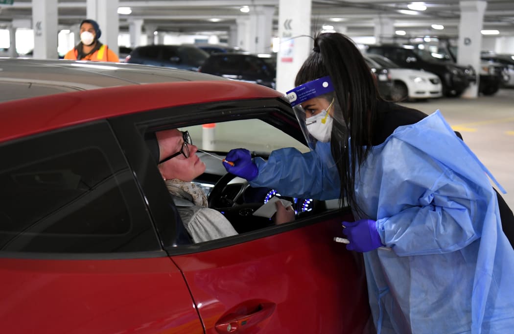 Medical staff perform a Covid-19 test at a drive-through testing site in a Melbourne carpark on 1 May.