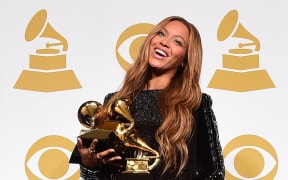 Beyoncé poses with her three Grammys during the 57th annual Grammy Awards in 2015.