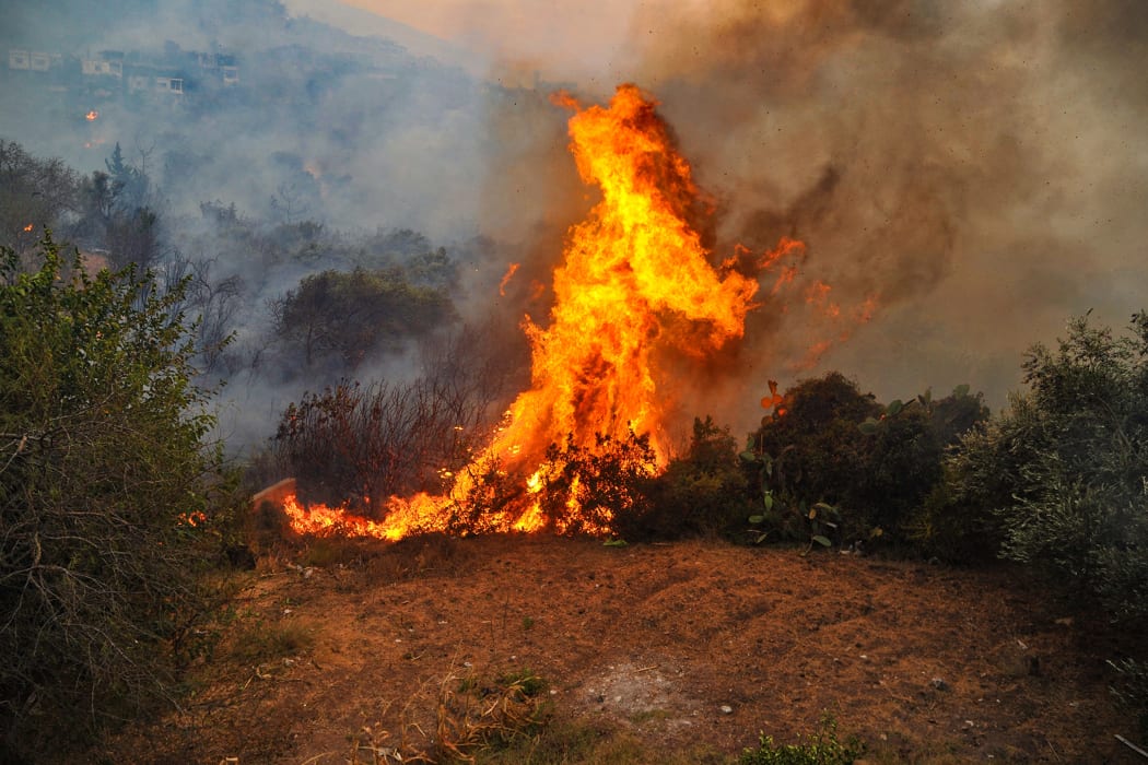 A handout picture released by the official Syrian Arab News Agency (SANA) on October 10, 2020 shows a fire devouring a forest in Syria's Latakia province the previous day.