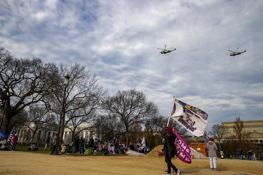 People gather in support of President Donald Trump to protest the outcome of the 2020 presidential election as Marine One fly's by the national mall on December 12, 2020 in Washington, DC.
