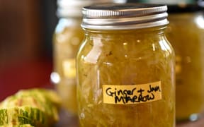 Glass jars full of a pale brown filling. A label on the jar says 'Ginger & Marrow Jam'.