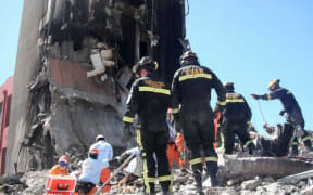Rescue workers on the site of the collapsed CTV building.