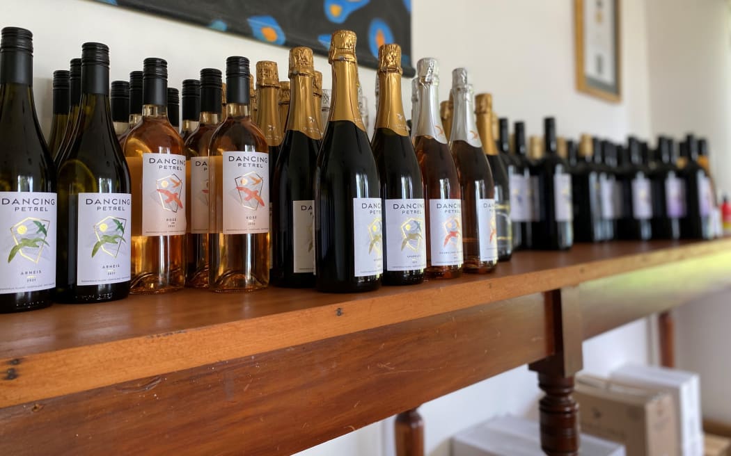 Dancing Petrel wines sit atop on old post office bench in the tasting room.