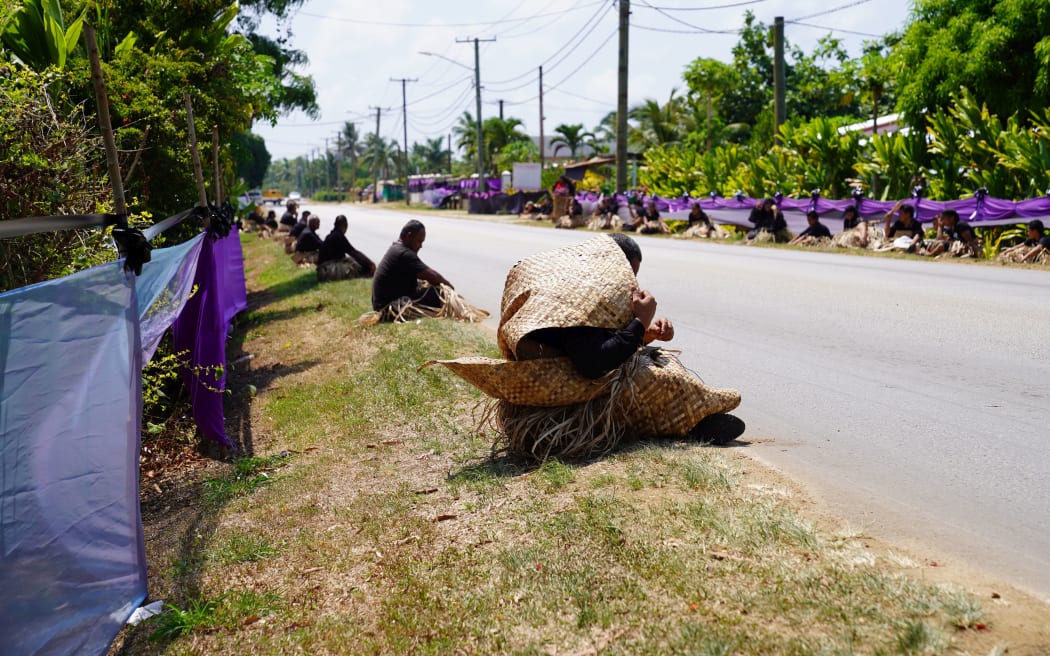 Mourners gather along Taufa'ahau Road at Vaini, Tongatapu, waiting for the funeral procession of  Lord Ma'âfu to pass by.