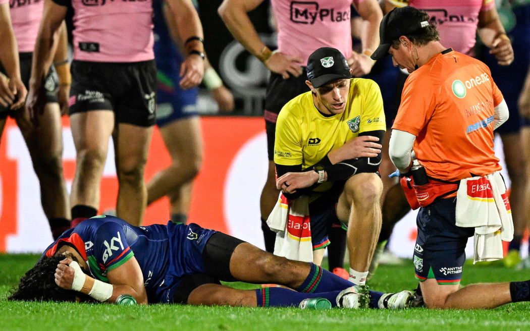 Dallin Watene-Zelezniak of the Warriors lies on the ground injured, NZ Warriors v Penrith Panthers.