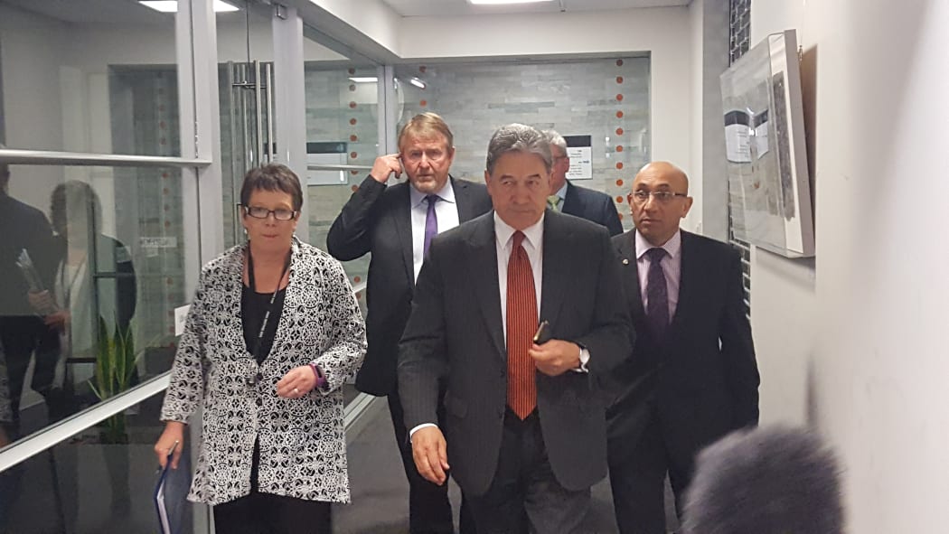 Winston Peters (front) emerging from his meeting with National.