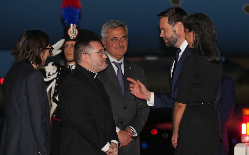 Second lady Usha Vance (R)  and Vice President JD Vance are greeted upon arrival on Air Force Two by Bruno Pasquino, chief of protocol, Italian Ministry of Foreign Affairs, monsignor Christopher Washington, head of english section, Holy See Secretariat, and Laura Hochla, foreign service officer for the U.S. Embassy to the Holy See, at Leonardo da Vinci International Airport in Rome Fiumicino, on May 17, 2025. (Photo by Jacquelyn Martin / POOL / AFP)