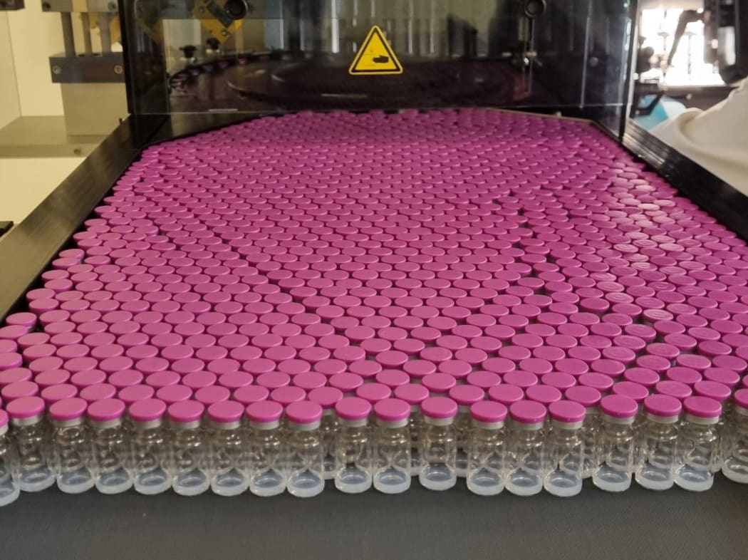 Vials being filled with the Pfizer/BioNTech Covid-19 vaccine on a production line at the Delpharm plant in Saint-Remy-sur-Avre, northern France.