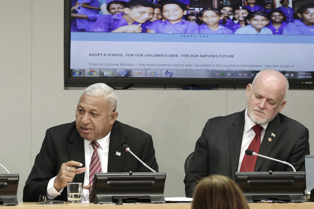 Josaia Voreqe Bainimarama (left), Prime Minister of the Republic of Fiji, briefs journalists on the "Implementation of the Paris Agreement - Consequences for the Humanitarian Summit and the 2030 Development Agenda". Peter Thomson (right), Permanent Representative of Fiji to the UN.
