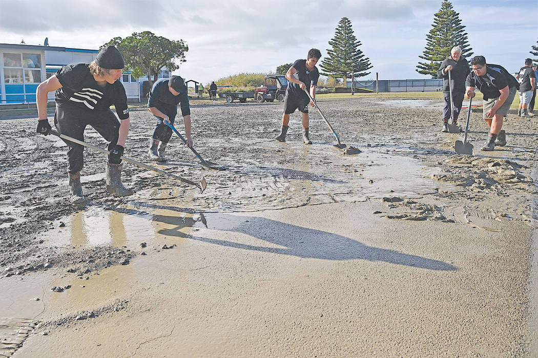 A team at work on the mud at Hatea a Rangi School, from left, Fergus Knight, Whetu Beale, Turoa Kohatu and Hauiti Kohatu.