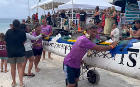 Paddlers are welcomed back to land following the grueling 36km race.