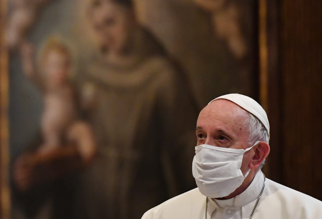 Pope Francis wears a protective face mask ahead of an inter-religious prayer service.