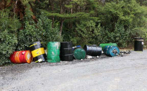 Oil barrels left at a carpark in the Waitakere ranges.