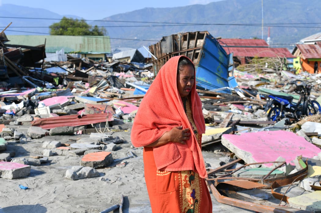 Quake survivor Nurhayati walks at an area where her house once stood in Lere subdistrict in Palu, Indonesia's Central Sulawesi.