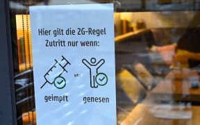 Poster on cafe window in Hessen, Frankfurt/Main, Germany saying: "The 2G rule applies here. Admission only if vaccinated or recovered".