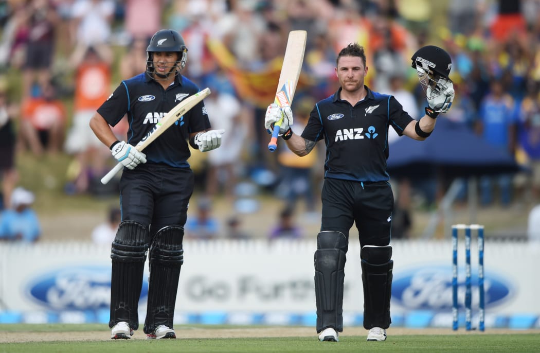 Black Caps' Brendon McCullum (R) celebrates his century as Ross Taylor looks on.