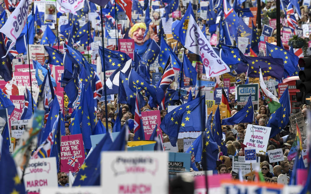 Demonstrators hold placards and EU and Union flags as they take part in a march by the People's Vote organisation in central London on October 19, 2019, calling for a final say in a second referendum on Brexit.