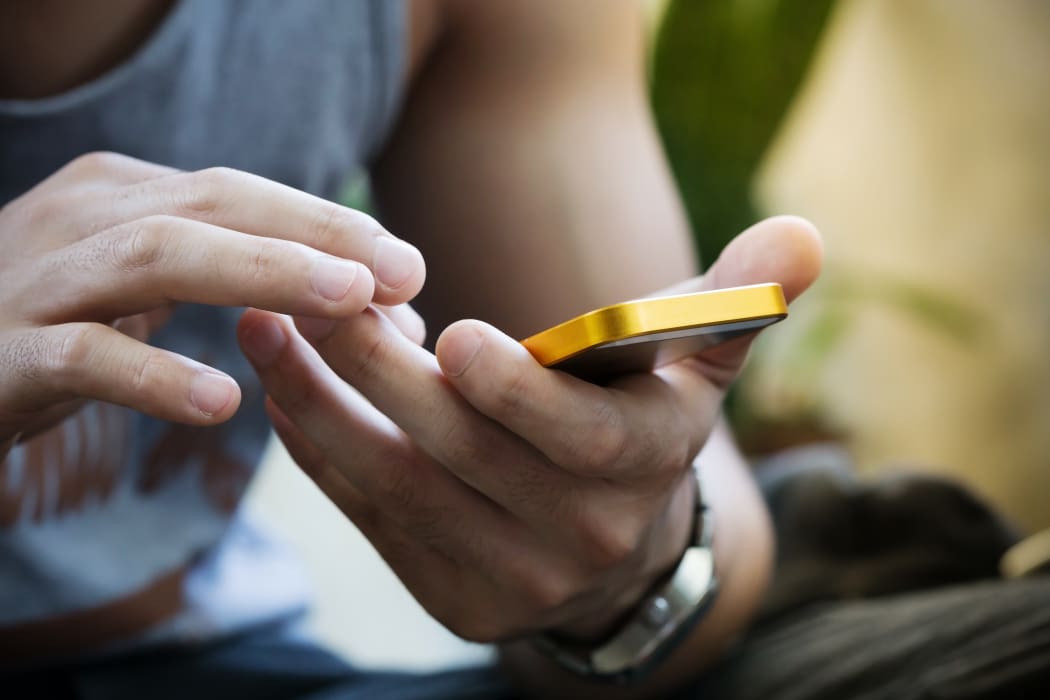 lifestyle young man using a mobile phone with texting message on app smartphone, playing social network and shopping online