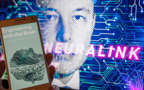 Neuralink logo, Elon Musk on screen in the background. Neuralink Corporation is a neurotechnology company that develops implantable brain-computer interfaces.