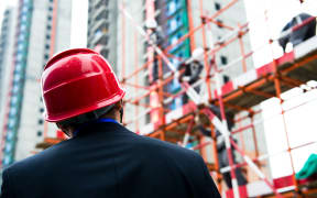 Builder inspector checking a construction site works.