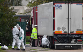British forensics officers work on a lorry, found to be containing 39 dead bodies, east of London, 23 October 2019.