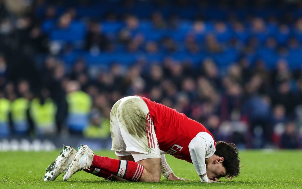 Hector Bellerin of Arsenal kisses the pitch.