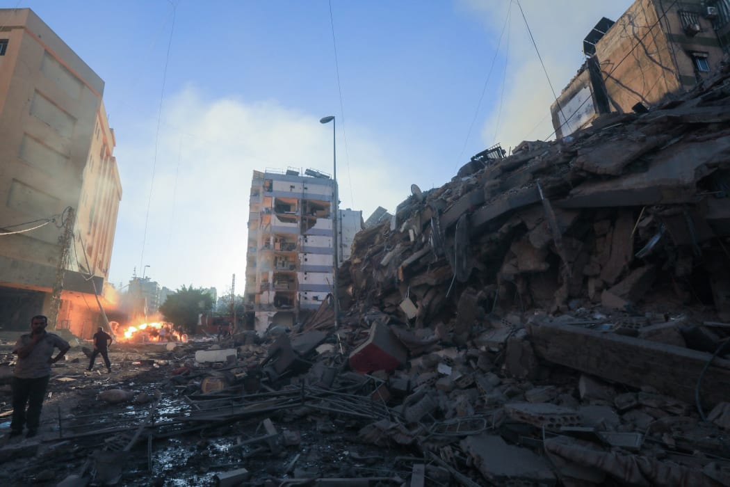 Residents inspect the damage following Israeli airstrikes on the Mreijeh neighbourhood in Beirut's southern suburbs on 4 October, 2024.