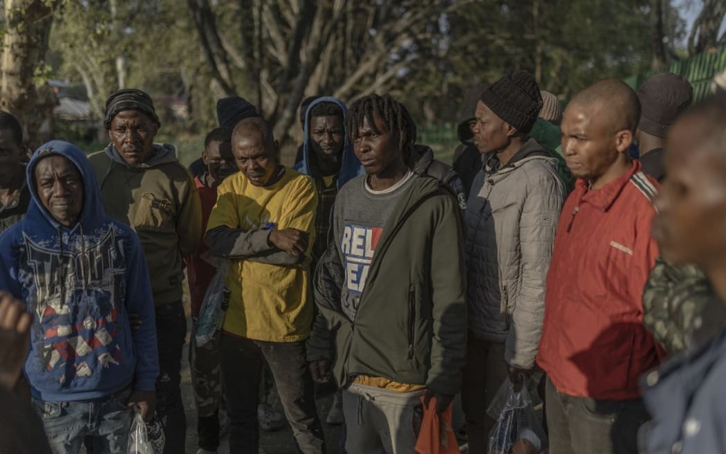 Survivors of the fire that ripped through the five-storey building arrive at a provisional shelter in Johannesburg on 1 September, 2023.