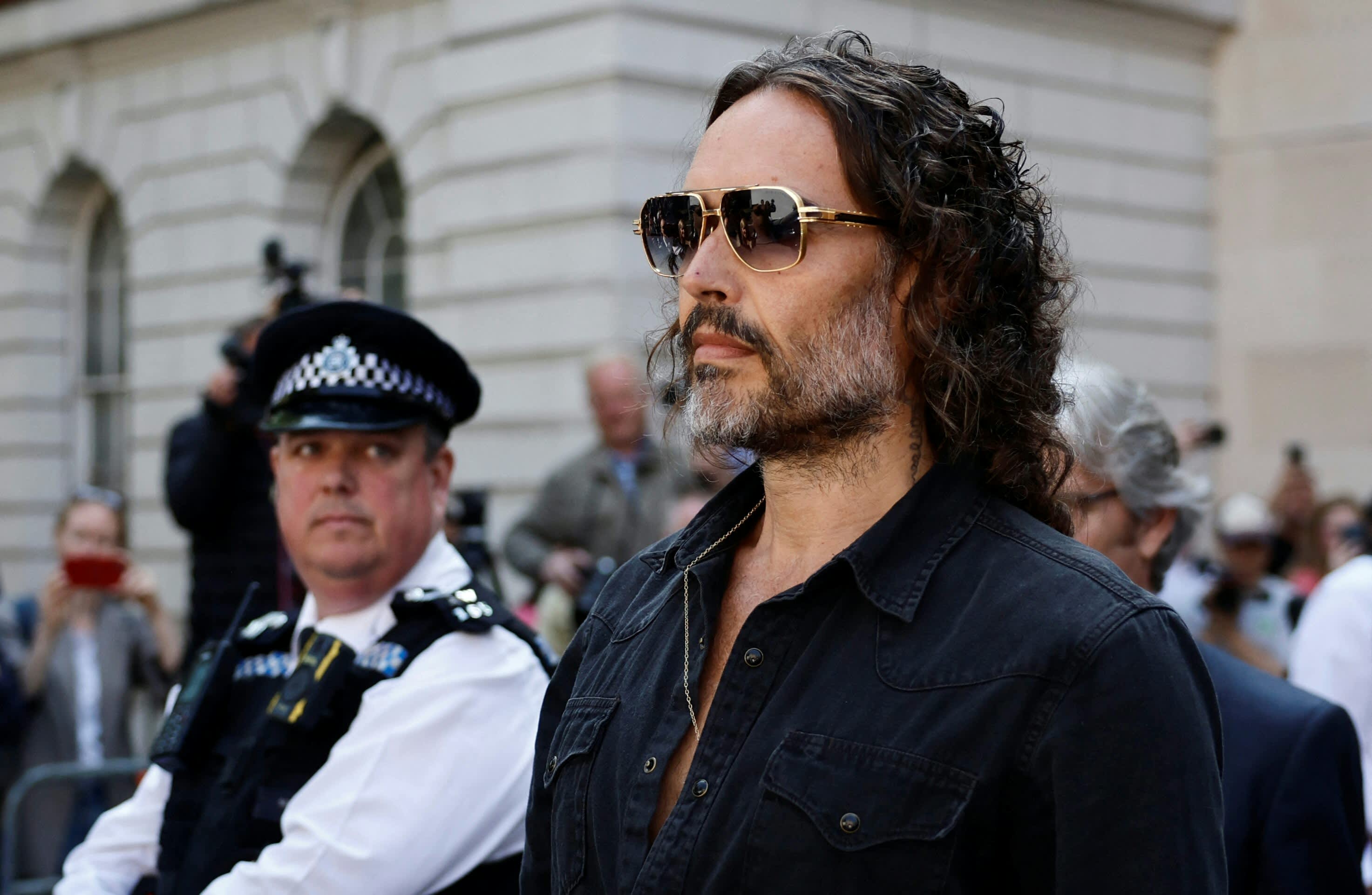 British actor and comedian Russell Brand departs Westminster Magistrates Court in London on May 2, 2025. British comedian and actor Russell Brand was on Friday bailed by a London court after he appeared to face five charges of rape and other sexual offences. (Photo by BENJAMIN CREMEL / AFP)