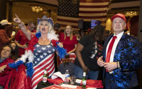 Stephanie Smith, left, and Thomas Brewer react to election results at the Nevada GOP election watch party in Las Vegas, Nevada on November 5, 2024. (Photo by Ronda Churchill / AFP)