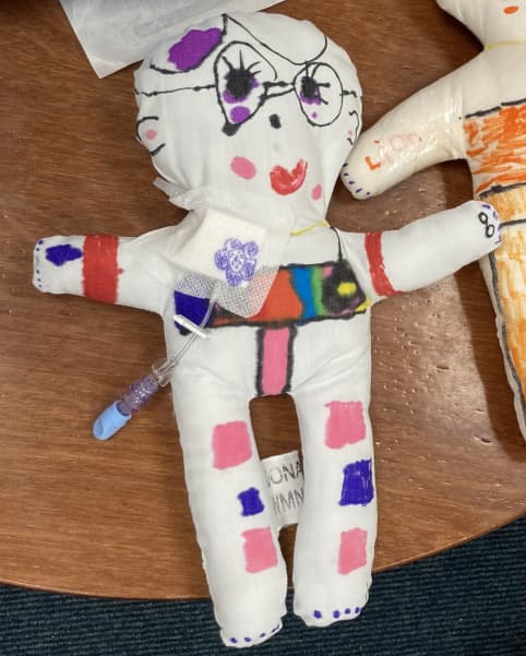 Hospital Play specialists give young children dolls to decorate which the specialists then use to explain medical procedures for children.