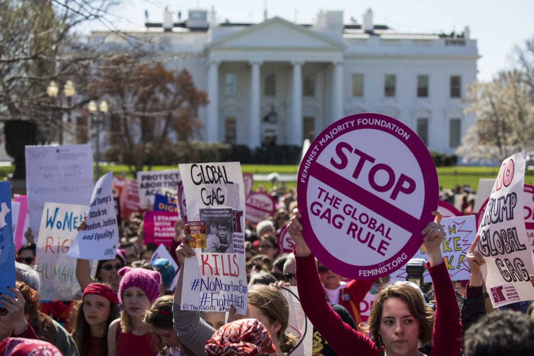 Women gather outside the White House on International Women's Day