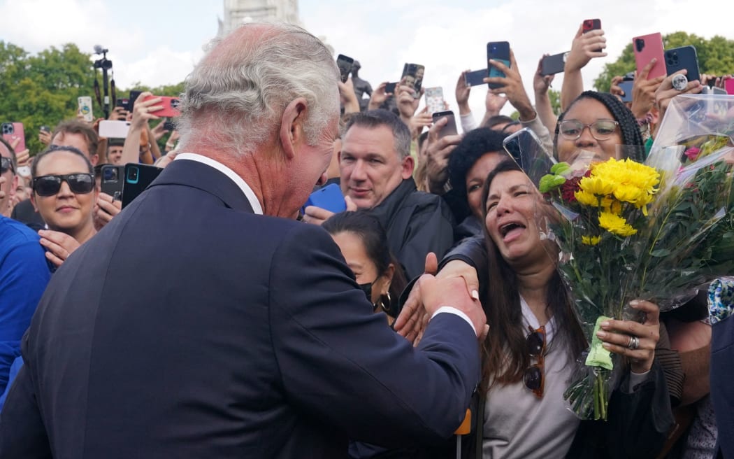 Britain's King Charles III and Britain's Camilla, Queen Consort greets the crowd upon arrival at Buckingham Palace in London, on September 9, 2022, a day after Queen Elizabeth II died at the age of 96.