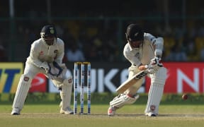 New Zealand's Luke Ronchi plays a defensive shot during the fourth day of the first cricket test match between India and New Zealand at Green Park Stadium in Kanpur on September 25, 2016.